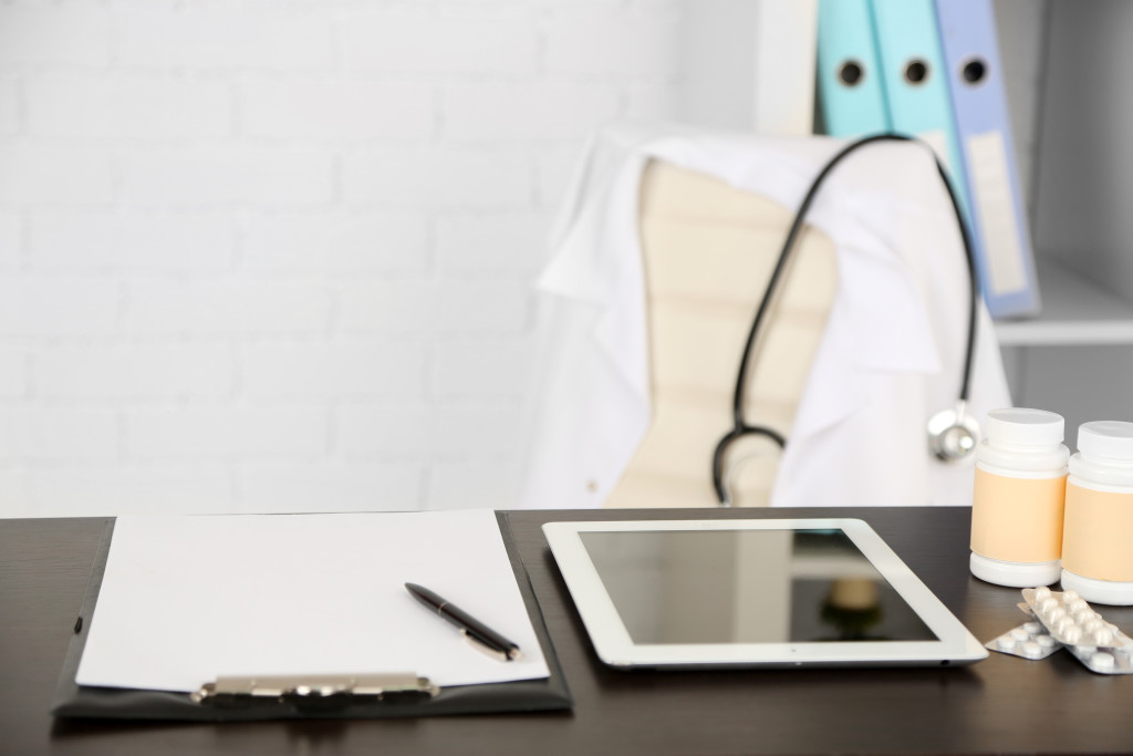 clipboard and tablet on desk in medical office. 